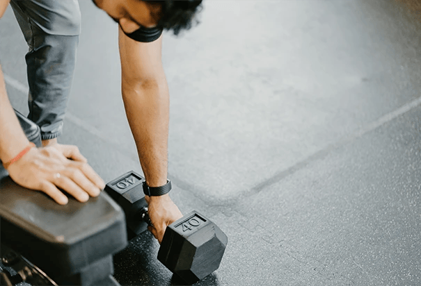 man lifting weights at home