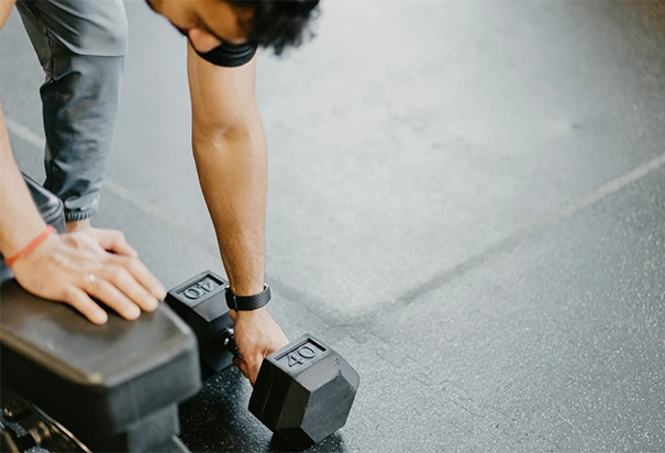 man lifting weights at home