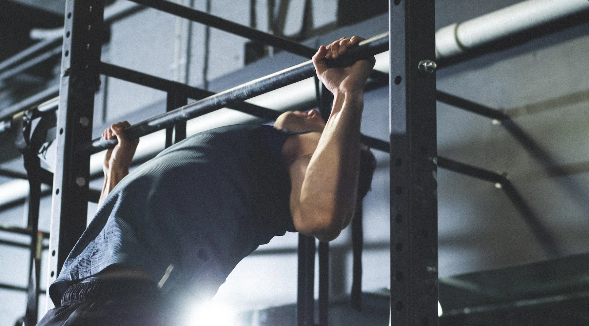 Man doing push ups on horizontal bar